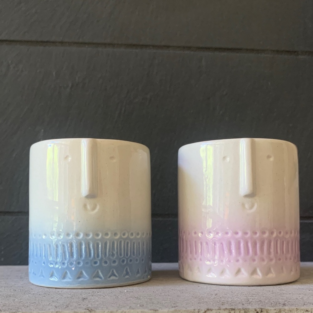 Pair of small ceramic face pots in cream, blue & lavender